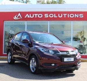 Honda HR-V, front right side view, red color, out front of auto solutions showroom